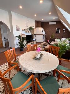 a dining room with a table and chairs at Apart Samont in Velký Ořechov