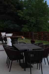 a group of tables and chairs in front of a fence at Ares Chalet in Horezu