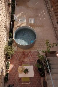 an overhead view of a swimming pool in a courtyard at Maisons Vaudésir - Lyla, Chablis in Chablis