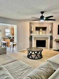 a living room with a couch and a fireplace at Grand Springwater Estate in Savannah