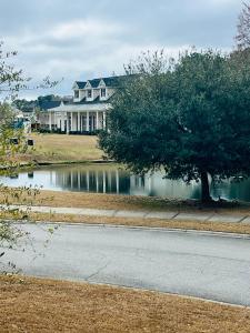 a large house with a pond in front of a house at Grand Springwater Estate in Savannah