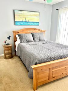 a bedroom with a bed with a wooden bed frame at Grand Springwater Estate in Savannah