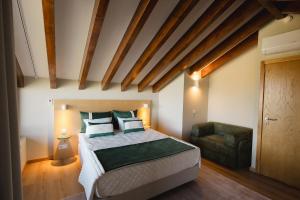 a bedroom with a large bed and a chair at KV Residences  +78 photos