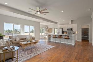 a living room and kitchen with a ceiling fan at Megginson Apartments in Dasmariñas