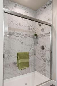 a bathroom with a shower with a glass door at Megginson Apartments in Dasmariñas +13 photos