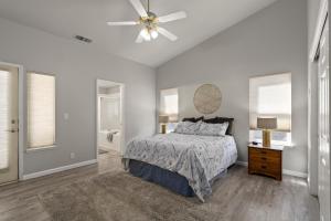 a bedroom with a bed and a ceiling fan at Megginson Apartments in Dasmariñas
