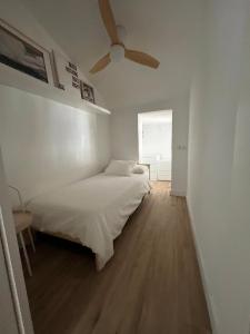 a bedroom with a bed and a ceiling fan at El Palomar in El Arenal