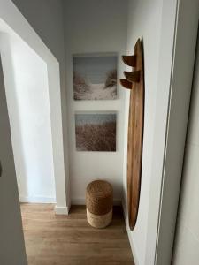 a hallway with two pictures and a bench and a wall at El Palomar in El Arenal +1 photo