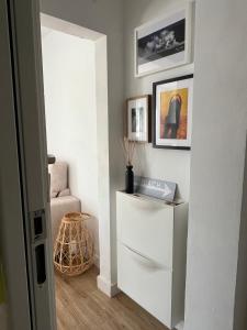 a living room with a white cabinet and a chair at El Palomar in El Arenal