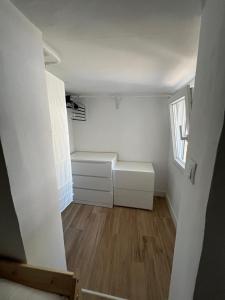 a small room with white walls and wooden floors at El Palomar in El Arenal