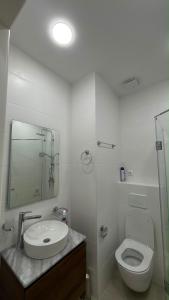 a bathroom with a toilet and a sink and a mirror at next green in Makhinjauri +5 photos