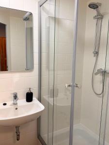 a bathroom with a sink and a shower at City Event Hotel in Dinslaken