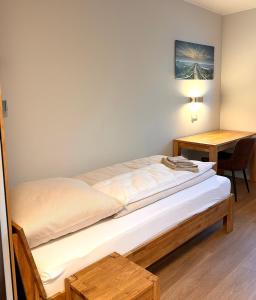 a bedroom with a bed and a desk and a table at City Event Hotel in Dinslaken +8 photos