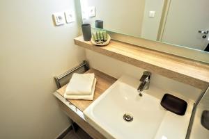 a bathroom with a sink and a mirror at Molière ChicSuites in Paris
