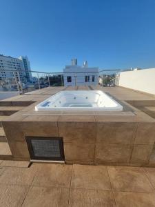 a large tub on top of a building at 2BR-3BA Condo Block from Beach w Rooftop Jacuzzi in Mazatlán