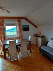 a living room with a table and chairs and a couch at Apartment Haus Dengg in Mauterndorf