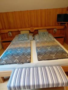 a large bed in a room with a bed frame at Apartment Haus Dengg in Mauterndorf