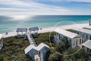an aerial view of a beach with houses and the ocean at Magnolia Honeymoon Cottage in Santa Rosa Beach
