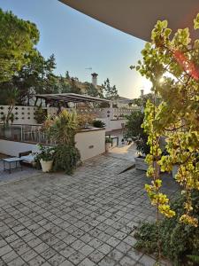 a patio with benches and plants on a building at Hotel Marisma Sancti Petri in Chiclana de la Frontera