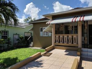 a house with a gate and a porch at Villa Vista in Steer Town