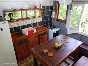 a small kitchen with a wooden table and a table with cheese at Dali in La Pedrera