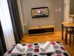 a room with a bed and a tv on the wall at Niški kutak in Niš +1 photo