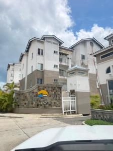a large apartment building with a fence in front of it at Playa dorodo in La Chorrera