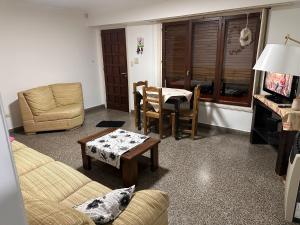 a living room with a couch and a table at French in Tres Arroyos