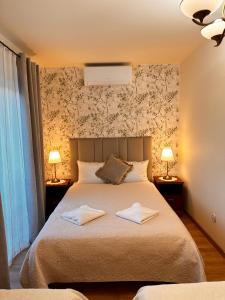 a bedroom with a bed with two towels on it at Zielona Przystań - Noclegi in Maków Podhalański