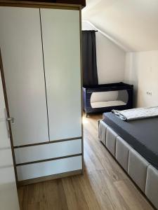 a bedroom with a bed and a sliding door at Biser jezera in Gornja Šuma