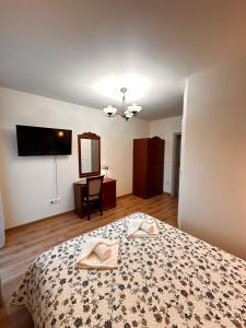 a bedroom with a bed with a towel on it at Zielona Przystań - Noclegi in Maków Podhalański