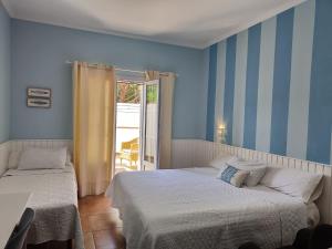 two beds in a room with blue walls at Hotel Marisma Sancti Petri in Chiclana de la Frontera +89 photos