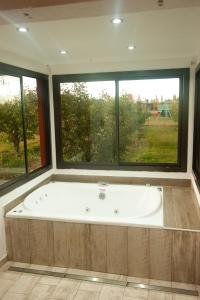 a large bath tub in a room with windows at Cabañas Morita Mia in San Rafael