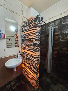 a bathroom with a shower and a sink at Кімната в квартире in Kyiv