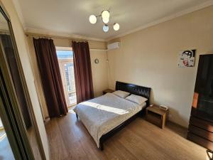 a small bedroom with a bed and a window at Кімната в квартире in Kyiv