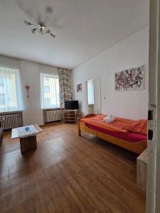 a large room with a bed and a couch at Monteurwohnungen Santos Lerch in Krefeld