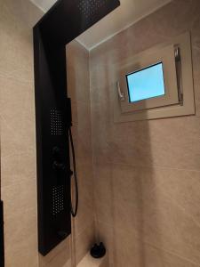 a bathroom with a shower with a window at Porto Minimal Oasis in Porto Rafti +7 photos