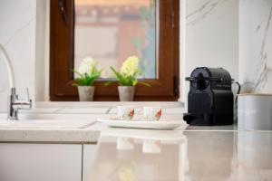 a kitchen counter with two coffee cups on a plate at Casa di Fava in Agios Nikolaos +39 photos