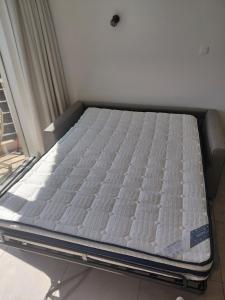 a bed sitting in a room next to a window at ANGEL in Bredene