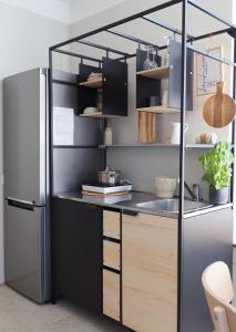 a kitchen with a refrigerator and a counter at APPART en THÈSE Appartement climatisé Accessible PMR Proche Dijon et CEA Valduc in Moloy