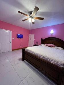 a bedroom with a bed and a ceiling fan at Private Executive Master Suite - Parham, Antigua in Vernons