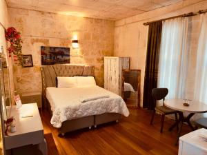 a bedroom with a bed and a table and chairs at Fazilet Hanım Konağı in Şahinbey