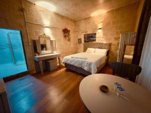 a bedroom with a bed and a table in it at Fazilet Hanım Konağı in Şahinbey