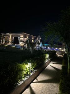 a house at night with lights in front of it at Sukoon Farms in Greater Noida