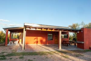 a small red house with a large patio at Cabañas Morita Mia in San Rafael