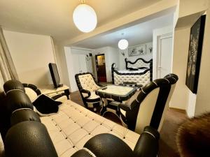a living room with a couch and a table at Faraon apartmani Beograd in Belgrade