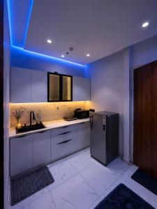 a kitchen with a sink and a refrigerator at Myro stays in Ghaziabad