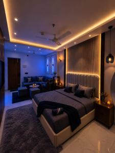 a bedroom with a large bed and a living room at Myro stays in Ghaziabad