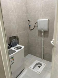 a small bathroom with a toilet and a sink at شاليهات الورد الفندقية in Ash Shuqayq +13 photos