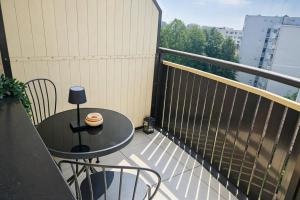 a balcony with a table with a cake on it at Kairos Apartments - Lothus - darmowy garaż podziemny, ścisłe centrum in Gliwice